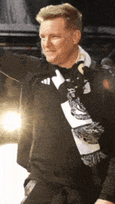 a man with a scarf around his neck that says ' boston ' on it