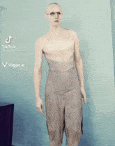 a man without a shirt is on a tik tok