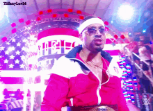 a man wearing sunglasses and a headband is standing in front of an american flag