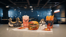 the word dragon is on a cup next to a burger