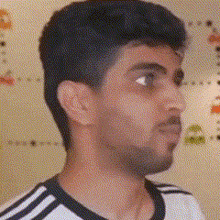 a man with a beard is wearing a black and white shirt