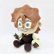 a stuffed cartoon character with brown hair and glasses is sitting on a white surface