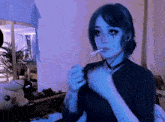 a girl with blue eyes is smoking a cigarette in a room