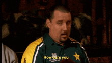 a man wearing a yellow shirt that says " how dare you "