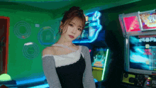 a woman is standing in front of a bunch of arcade games .