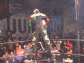 a blurred image of a person jumping in front of a crowd with a sign that says jump