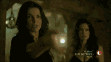a man is standing in front of a fireplace in a room that says the lottery on it