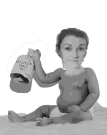 a baby in a diaper holding a bag that says " elizabeth smart baby "