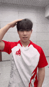 a man wearing a red and white shirt that says a on it