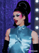 a picture of a drag queen with a tattoo on her arm