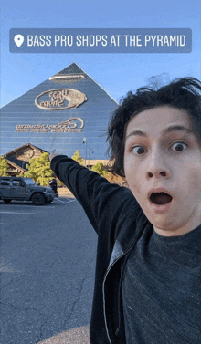 a man standing in front of a bass pro shops at the pyramid