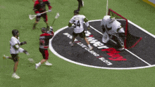 a lacrosse game is being played in front of an advertisement for live casino and slots