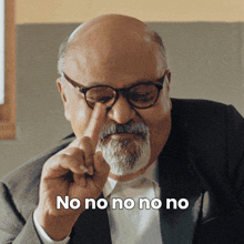a bald man with glasses and a beard says no