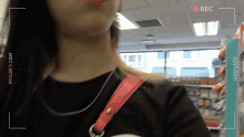a woman in a black shirt is being recorded by ryujin 's camera