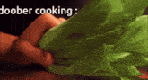 a person is holding a lettuce leaf with the words doober cooking written above it