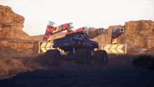 a monster truck is driving through a desert with arrows pointing in opposite directions