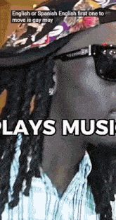a man with dreadlocks wearing sunglasses and a hat with the words english or spanish english first one to move is gay may plays music