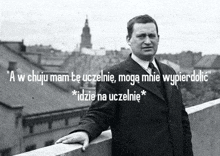 a man in a suit and tie is leaning against a railing with a quote in a foreign language .