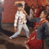 a man and a woman are dancing together in front of a crowd .