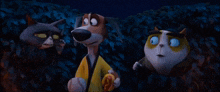 a dog and two cats are standing next to each other in a dark forest