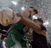 a basketball player wearing a green jersey with the number 20 on it