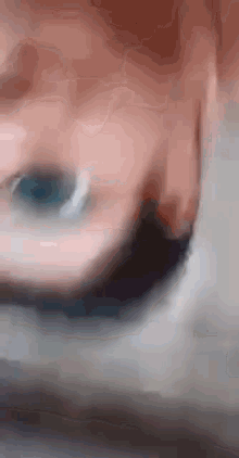 a close up of a person 's face with a blurry background .