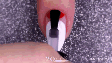 a close up of a person 's nails with a black and white design on them .