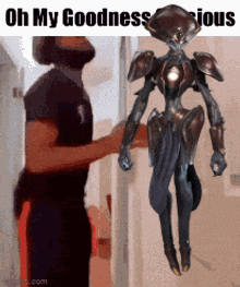 a picture of a man holding a robot that says oh my goodness