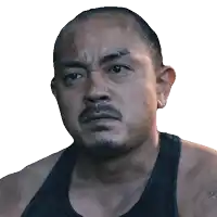 a man with a beard wearing a black tank top looks at the camera