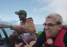 a man wearing a life vest that says ' hawaii ' on it smiles