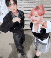 a man and a woman are dancing together on a sidewalk .