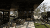 a patio area with a table and chairs under a covered roof