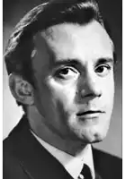a black and white photo of a man in a suit