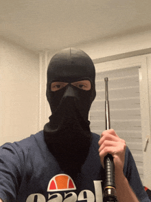a man wearing a mask and a shirt that says ellesse