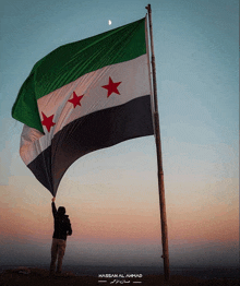 a hassan al ahmad photo of a person holding up a flag