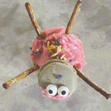 a close up of a cupcake with pink frosting