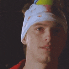 a man with a bandage on his head has the word kansas on his neck