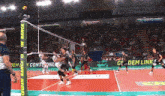 a volleyball game is being played with advertisements for credem banca