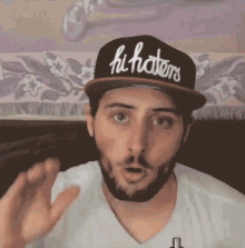 a man is wearing a hat that says hi haters