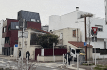 a white truck is parked in front of a building that has a sign that says " zone de circulation "