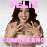 a woman in a pink dress says feliz cumpleanos