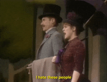 a man and a woman standing next to each other with the words i hate these people visible