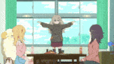 a girl with her arms outstretched is standing in front of a table with other girls