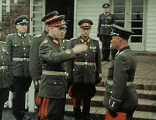 a group of men in military uniforms with the letter i on their sleeve