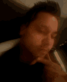 a blurry picture of a man 's face with his eyes closed