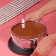 a person is putting a cake in a plastic container