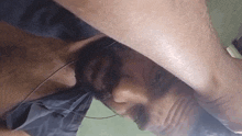 a close up of a person laying down with their head on their leg