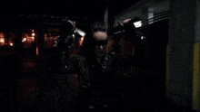 a woman holding two swords in a dark room
