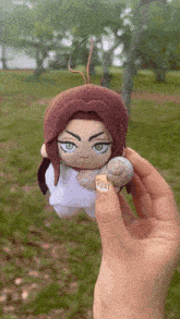 a person is holding a stuffed animal with a snail on it