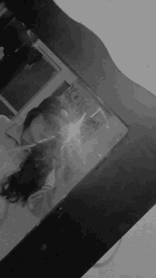 a black and white photo of a person taking a selfie in front of a mirror